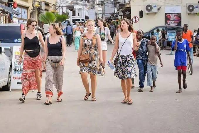 Tourist exploring Stone Town safely during guided walk